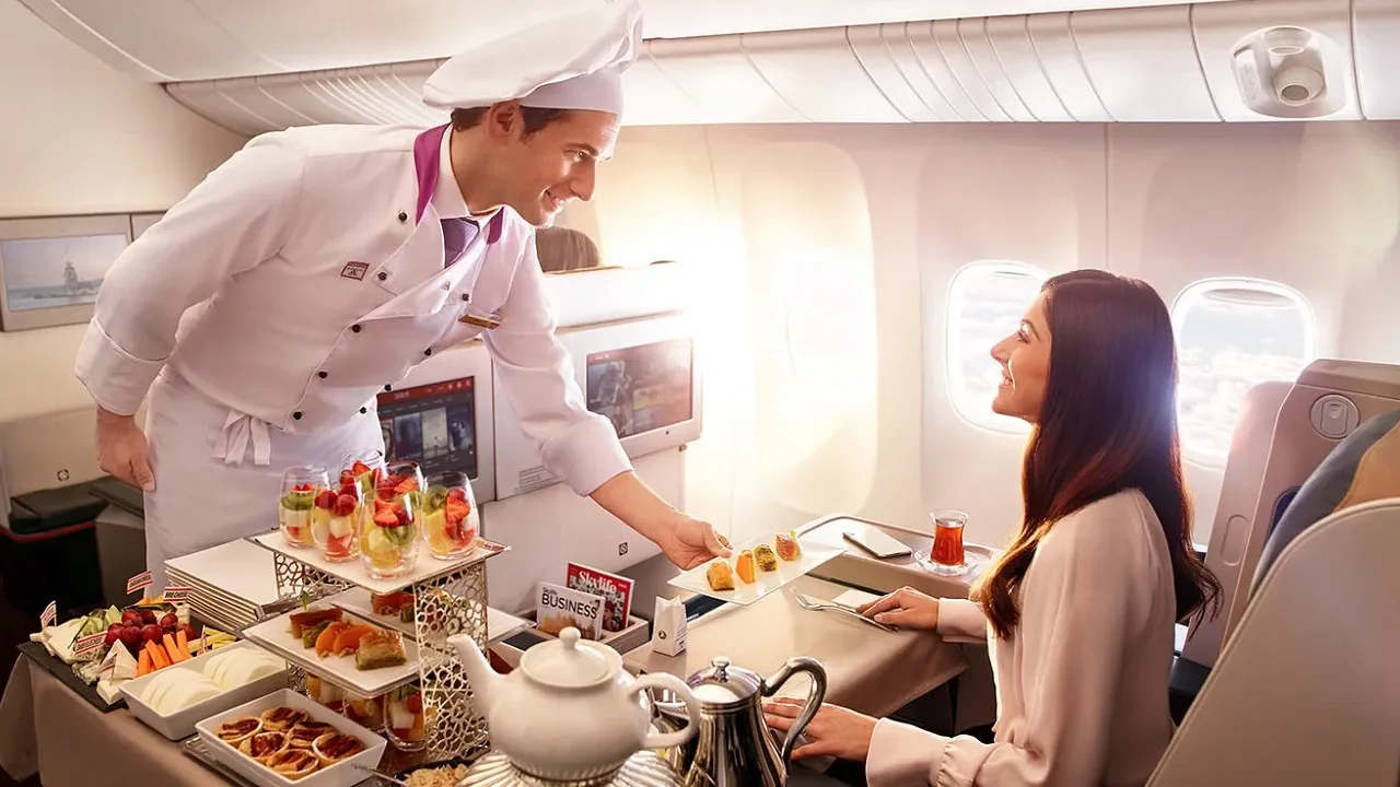 Passengers receiving in-flight meal service from airline crew