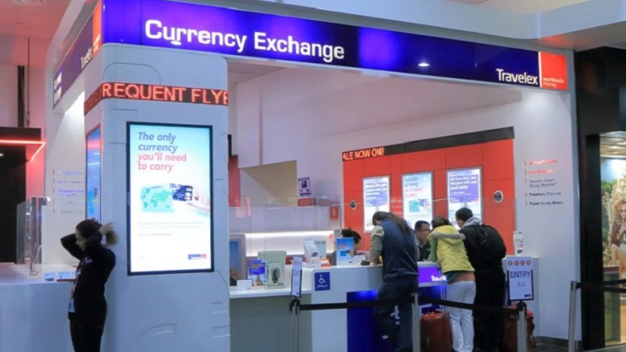 Currency Exchange at the International Terminal of ATL Airport counter with travelers waiting.  