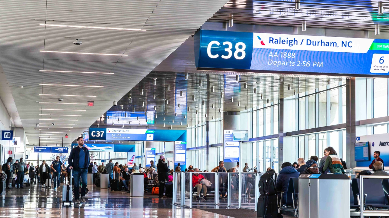 DFW TSA Wait Times and Schedules on Terminals with passengers waiting near departure gates.  