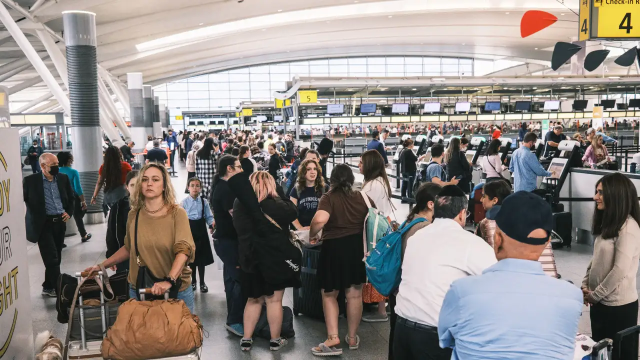 People waiting in a security line at JFK Airport.